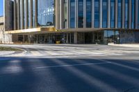 an image of a business building on the corner of a street where there are two traffic lights