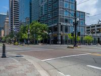 an intersection with buildings on both sides and a street light in the middle of the road