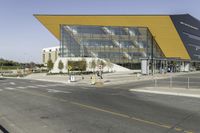 the building is modern and very sleek the yellow is just striking from outside to inside