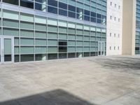 a large building with windows and some white doors in front of it's front