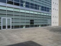 a large building with windows and some white doors in front of it's front