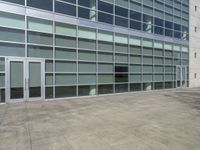 a large building with windows and some white doors in front of it's front