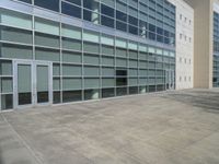 a large building with windows and some white doors in front of it's front