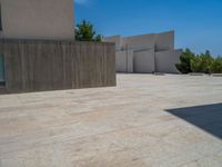 the gray concrete walls of a building have a line of steps on the left side