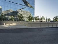 an empty street outside of an office building with several buildings on either side of it