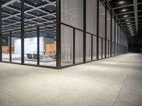 an open room with some furniture and some chairs in the middle of it, with glass wall and windows on both sides