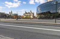 a street with an intersection in front of a building that looks like a glass - walled structure