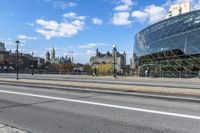 a street with an intersection in front of a building that looks like a glass - walled structure