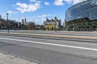 a street with an intersection in front of a building that looks like a glass - walled structure