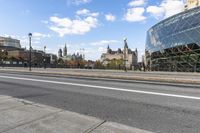 a street with an intersection in front of a building that looks like a glass - walled structure