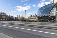 a street with an intersection in front of a building that looks like a glass - walled structure