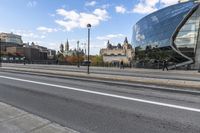 a street with an intersection in front of a building that looks like a glass - walled structure