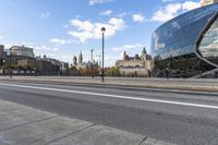 a street with an intersection in front of a building that looks like a glass - walled structure