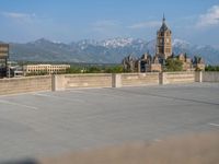 several large empty parking spaces in the city with buildings nearby in front of them -