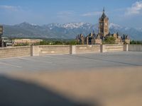 several large empty parking spaces in the city with buildings nearby in front of them -