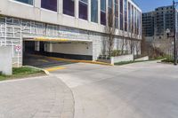 a parking garage entrance with yellow and purple painted on it's sides and a building in the background