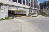 a parking garage entrance with yellow and purple painted on it's sides and a building in the background