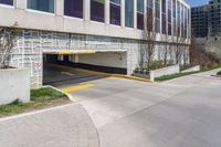 a parking garage entrance with yellow and purple painted on it's sides and a building in the background