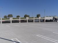 a large parking garage with several spots on the ground and cars parked in rows and one standing