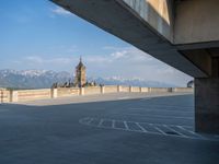 several large empty parking spaces in the city with buildings nearby in front of them -