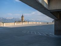 several large empty parking spaces in the city with buildings nearby in front of them -