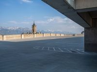 several large empty parking spaces in the city with buildings nearby in front of them -