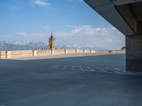 several large empty parking spaces in the city with buildings nearby in front of them -