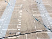 an overhead view of a parking area with multiple arrows in various directions and lines going down the street