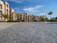 the driveway in the front of this block has several buildings with a parking space next to it