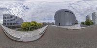 a circular panoramic view of the outdoors of a building and street with a ramp