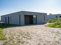 the three houses are made of concrete and a garage is designed to have an open - air roof