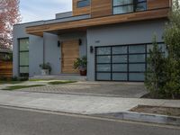 a very neat modern home is on the street corner in front of the house, looking into the road