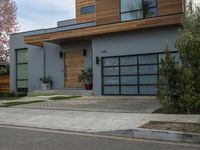 a very neat modern home is on the street corner in front of the house, looking into the road