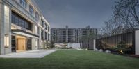 modern residential building with courtyard next to office building by architecture studio arno & co