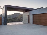 an outside garage door with mountains in the background and a couple of lights above it