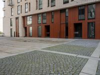 the building has brick tiles on each floor and red paneled walls on the outside