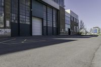 a warehouse yard has yellow lines and parking spaces for people to walk down the side of it