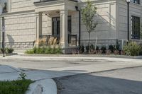 the building is tan in color and stone with a large entrance at the end of it