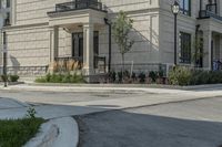 the building is tan in color and stone with a large entrance at the end of it