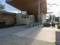 a building that is a modern, glass house in an urban cityscape with stone blocks