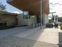 a building that is a modern, glass house in an urban cityscape with stone blocks