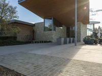 a building that is a modern, glass house in an urban cityscape with stone blocks