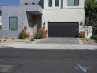 a very neat house with a small driveway in front of it and a big garage door