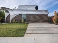 the house is all set up on a flat - faced concrete driveway, with a white perforated facade