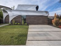 the house is all set up on a flat - faced concrete driveway, with a white perforated facade