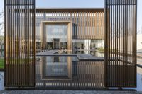 a small swimming pool surrounded by large wooden fences in the garden area of a house