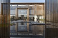 a small swimming pool surrounded by large wooden fences in the garden area of a house