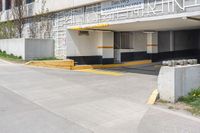 the entrance to a building that is on the street with yellow and white stripes on it