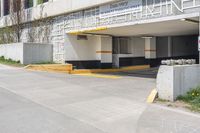 the entrance to a building that is on the street with yellow and white stripes on it