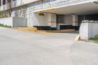 the entrance to a building that is on the street with yellow and white stripes on it